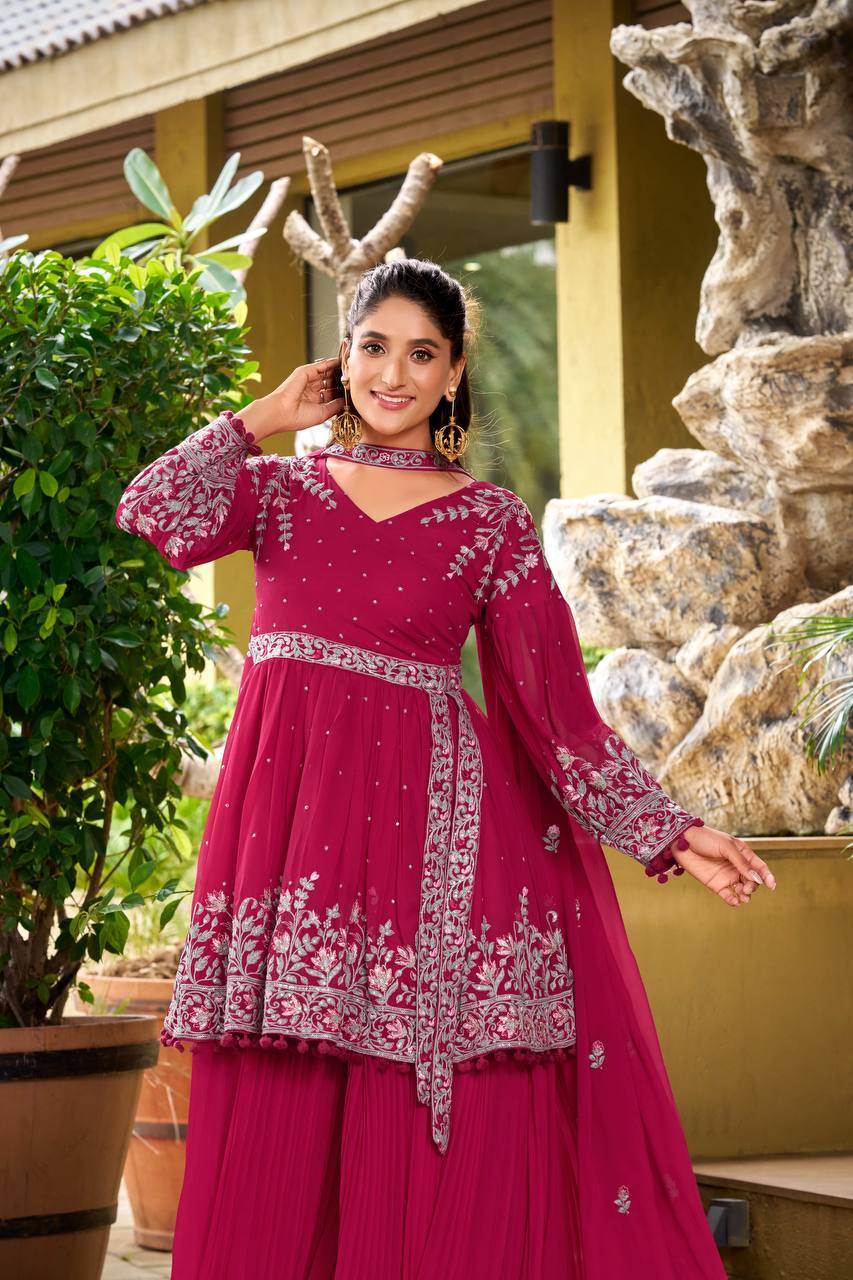 Front view of deep pink peplum palazzo set with silver thread embroidery on kurti and dupatta.